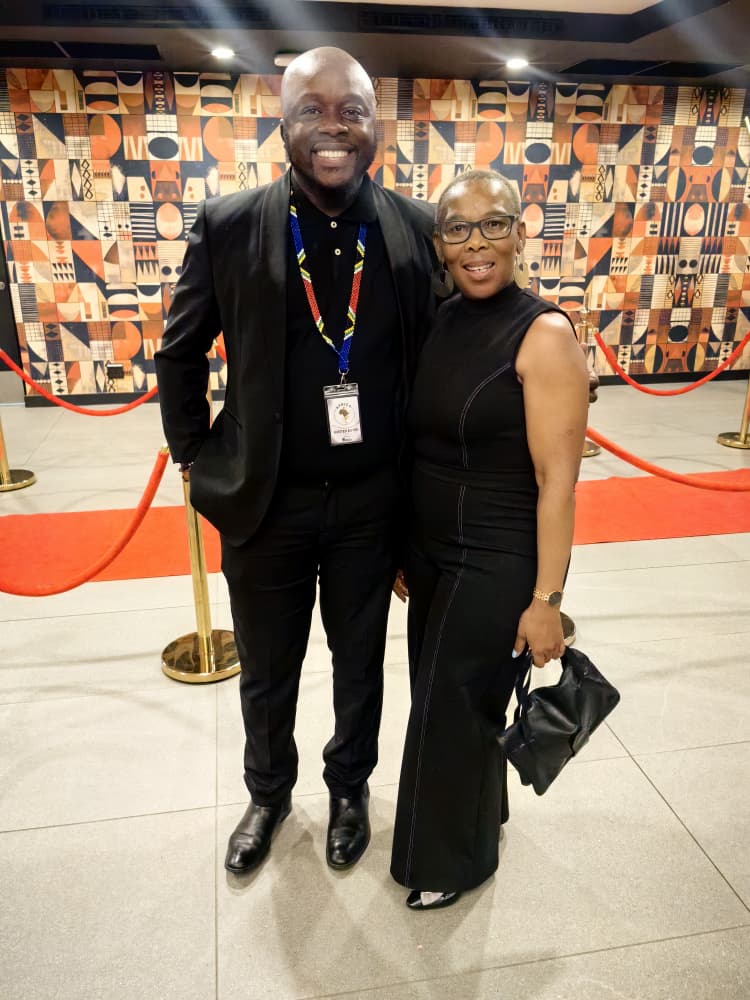 Kuda Kennedy Machiwana and a colleague on the AGTC convention red carpet